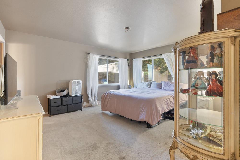 380 Hillside Road San Juan Bautista, CA 95045 - Photo 23 of 60 a spacious bedroom with a bed and glass door