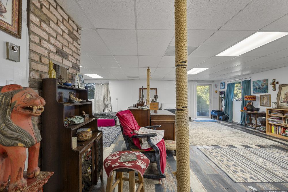 380 Hillside Road San Juan Bautista, CA 95045 - Photo 31 of 60 a living room with furniture a flat screen tv and a fireplace