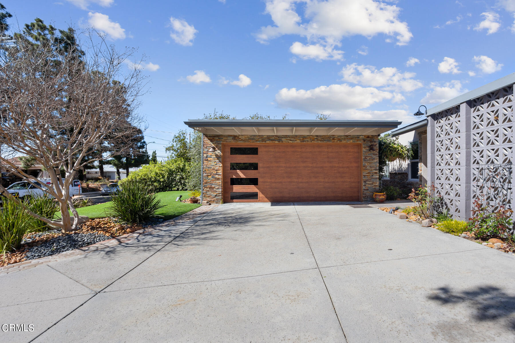 9400 Crystal View Drive Tujunga, CA 91042 - Photo 12 of 67 a front view of a house with a garage and a yard