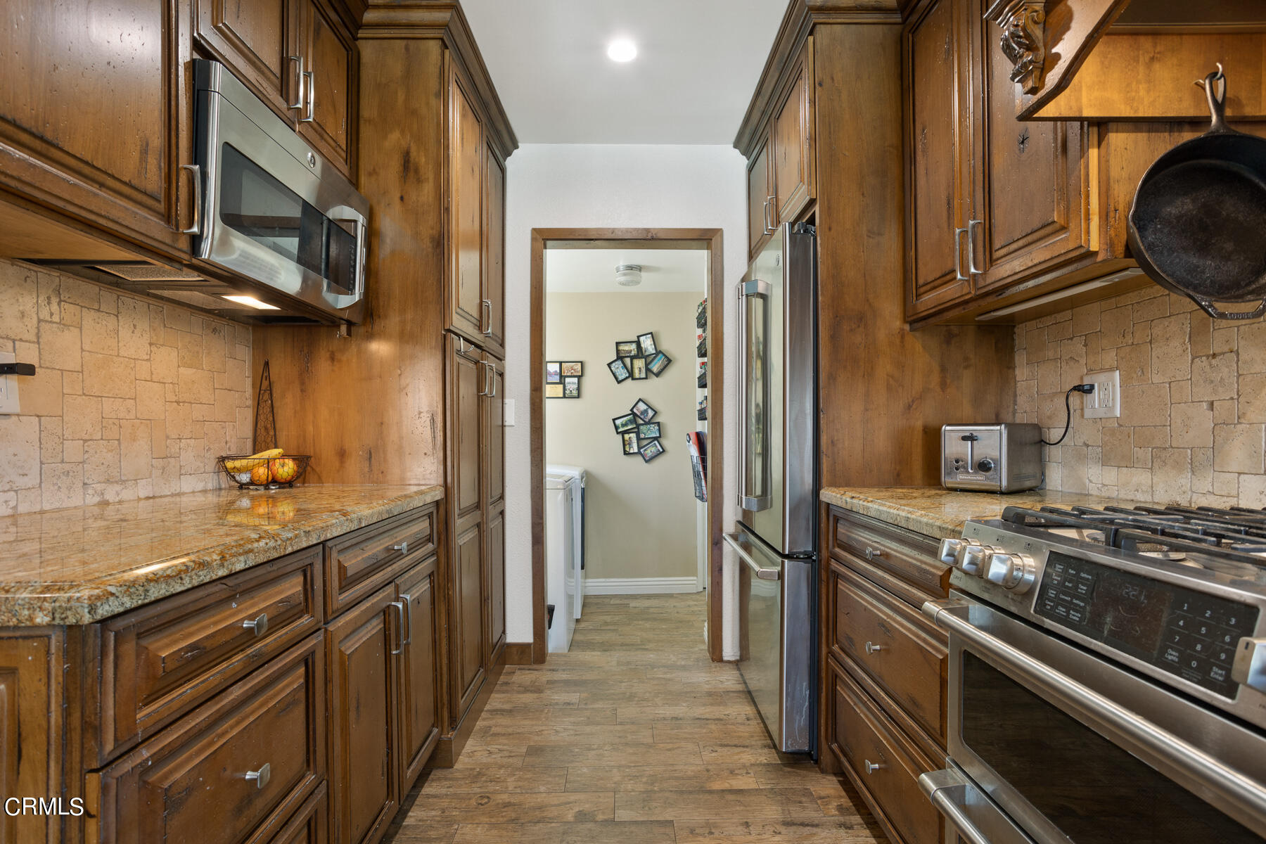 9400 Crystal View Drive Tujunga, CA 91042 - Photo 28 of 67 a kitchen with stainless steel appliances granite countertop a stove and a refrigerator