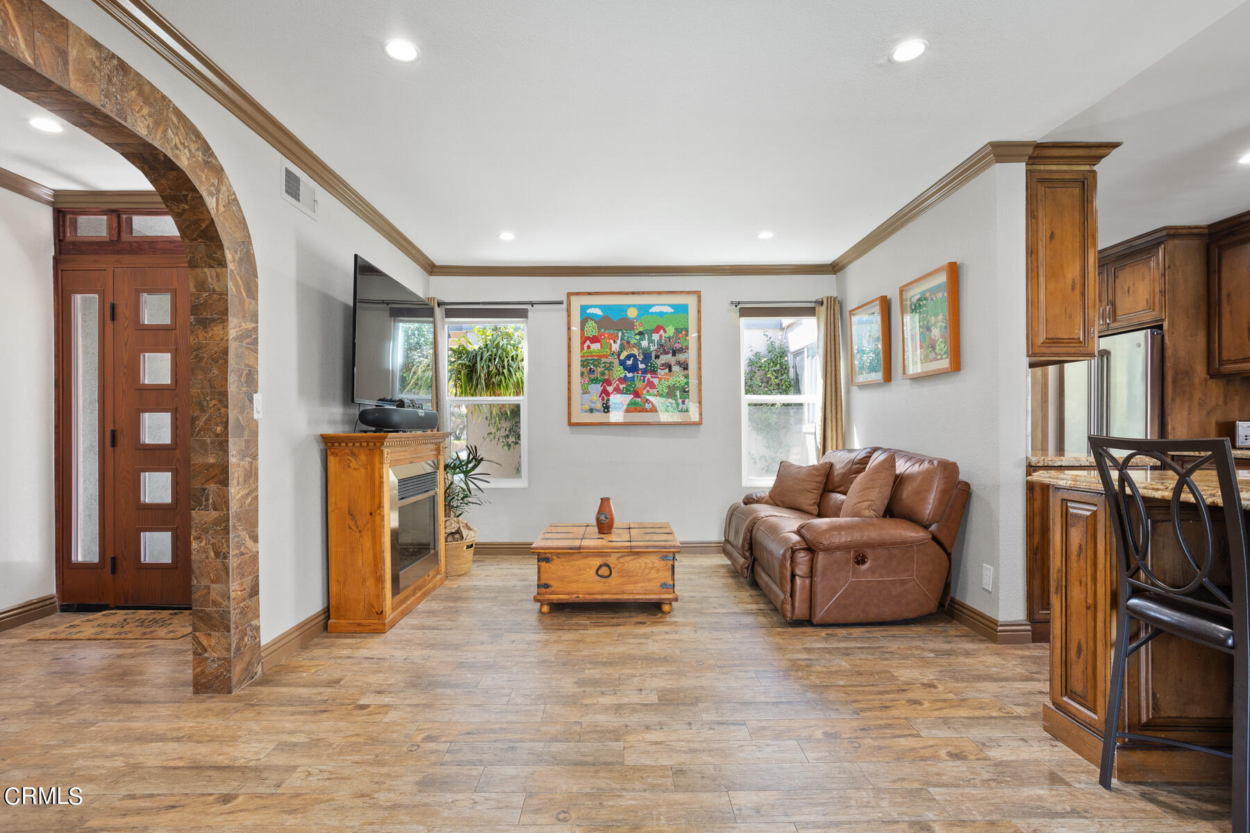 9400 Crystal View Drive Tujunga, CA 91042 - Photo 37 of 67 a living room with furniture a flat screen tv and a refrigerator