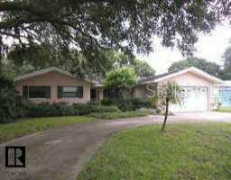 1835 Nursery Road Clearwater, FL 33764 - Photo 1 of 1 a backyard of a house with plants and large tree