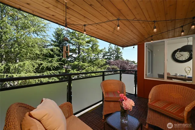 swimming pool view with a seating space and a garden view