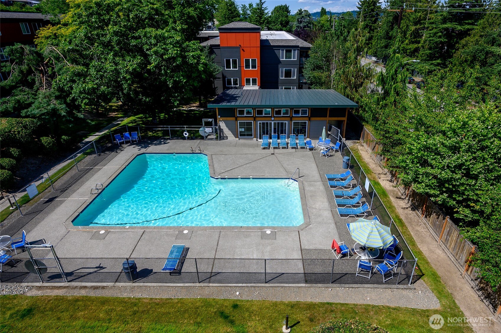 7021 Sand Point Way Northeast, Unit B319 Seattle, WA 98115 - Photo 16 of 29 swimming pool view with a seating space and a garden view
