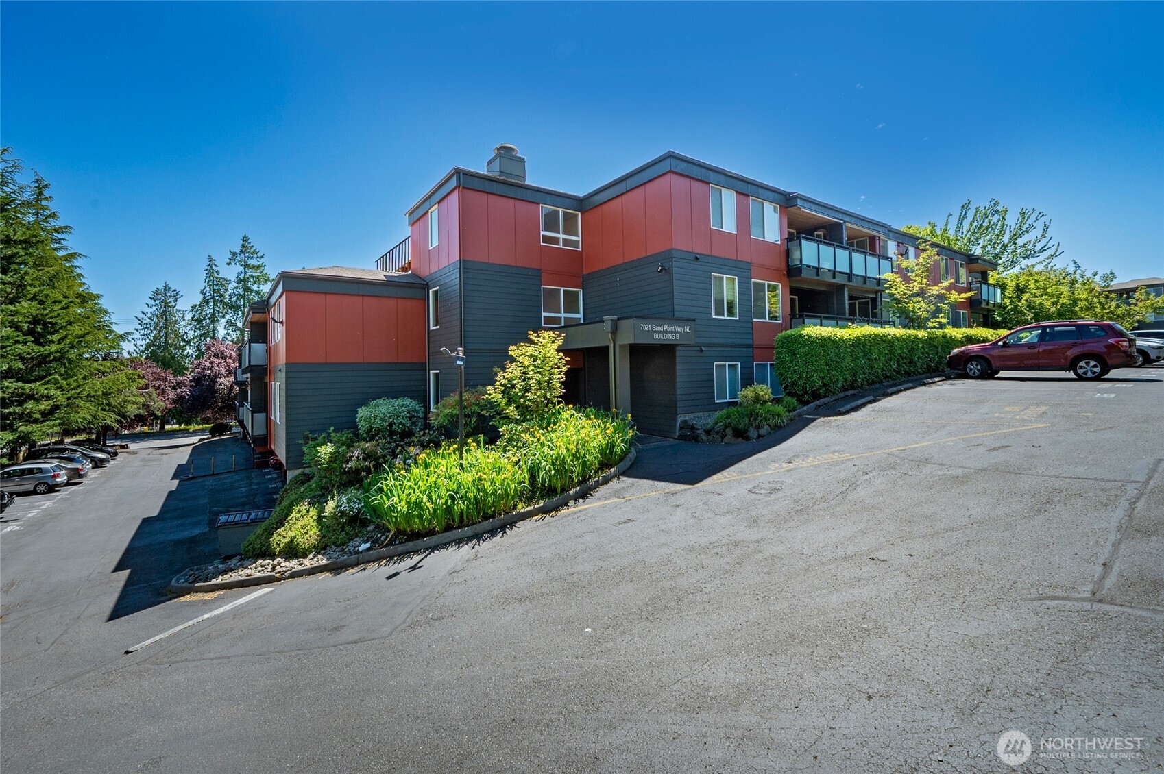 7021 Sand Point Way Northeast, Unit B319 Seattle, WA 98115 - Photo 18 of 29 a front view of a house with a yard and garage