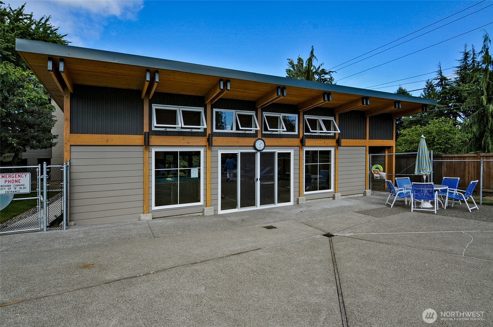 7021 Sand Point Way Northeast, Unit B319 Seattle, WA 98115 - Photo 19 of 29 a view of a house with a patio and a yard