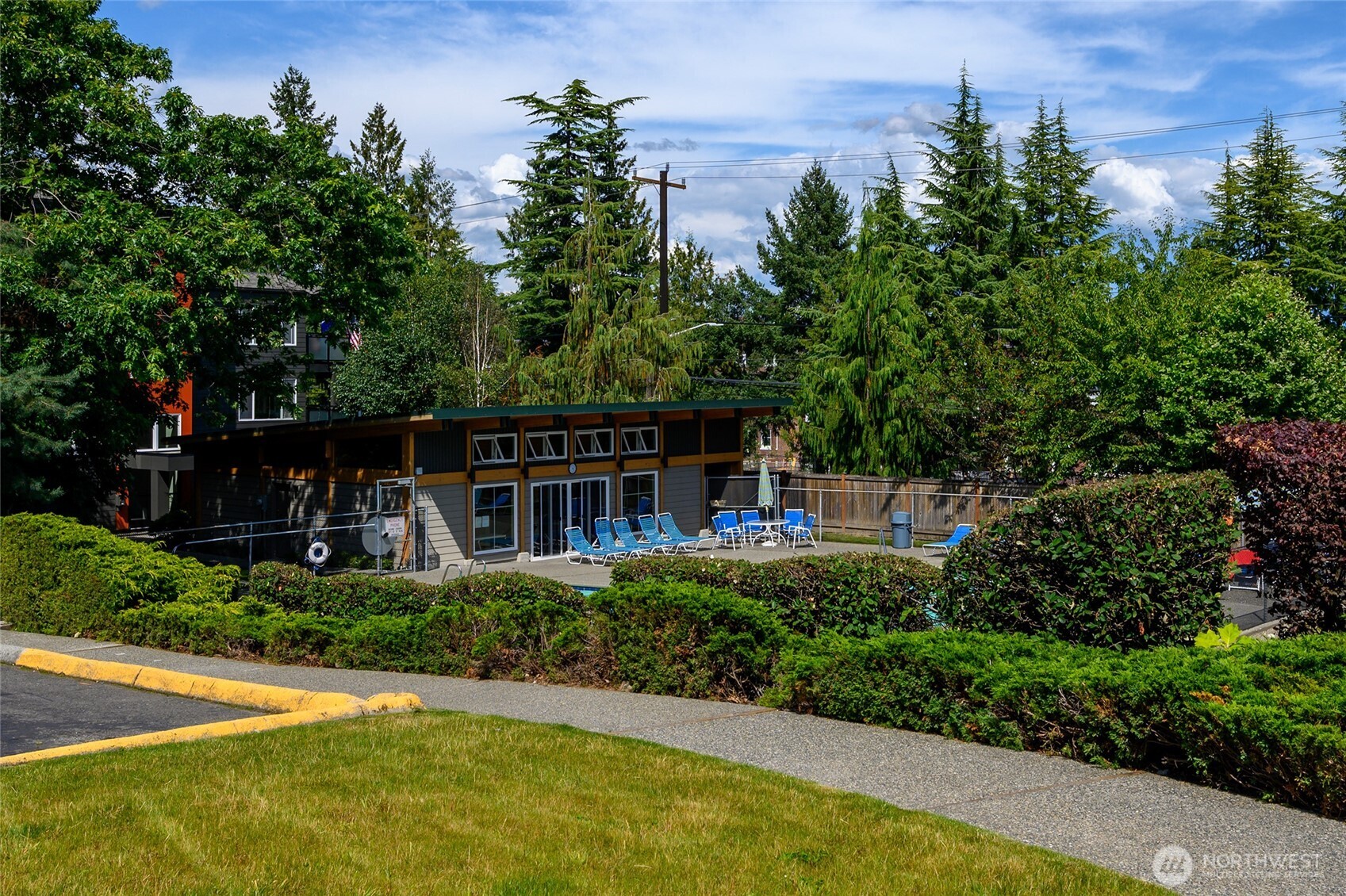 7021 Sand Point Way Northeast, Unit B319 Seattle, WA 98115 - Photo 25 of 29 a view of a garden with plants and large trees