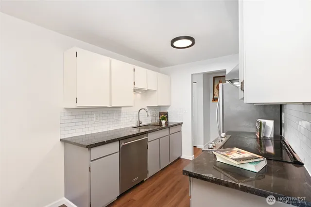 a kitchen with a sink stove and cabinets