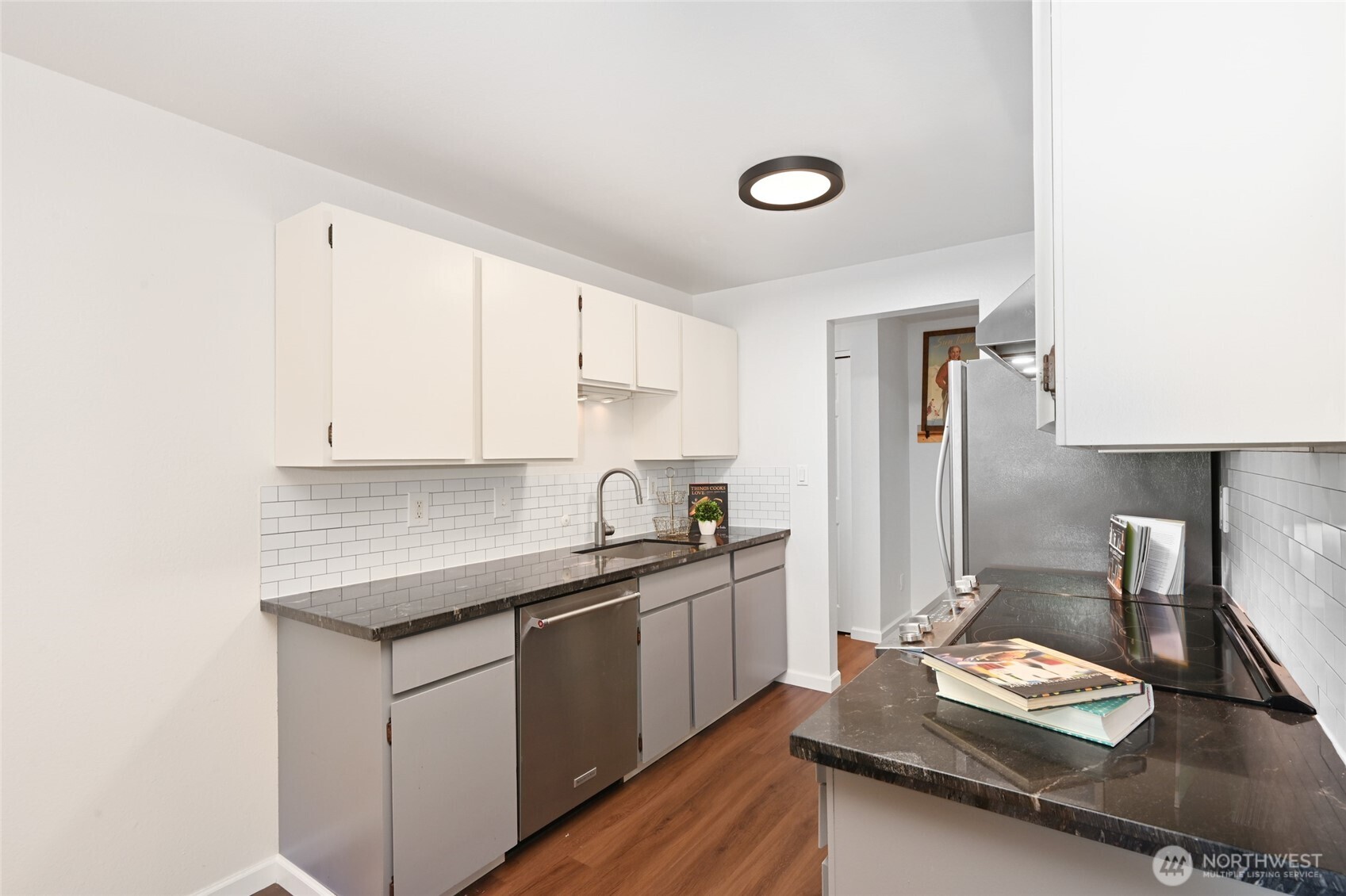 7021 Sand Point Way Northeast, Unit B319 Seattle, WA 98115 - Photo 6 of 29 a kitchen with a sink stove and cabinets