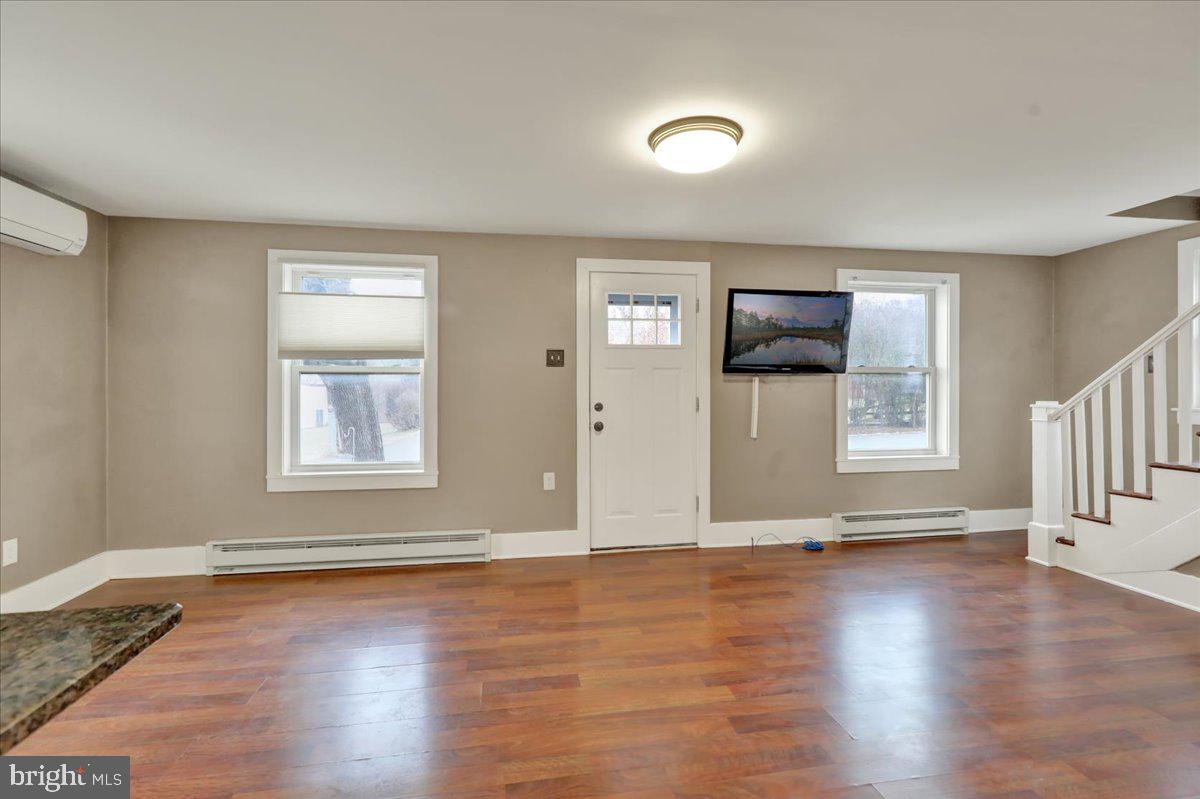 5145 Spruce Road Emmaus, PA 18049 - Photo 5 of 26 an empty room with wooden floor and windows