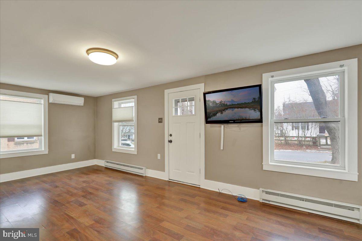 5145 Spruce Road Emmaus, PA 18049 - Photo 6 of 26 an empty room with wooden floor and windows