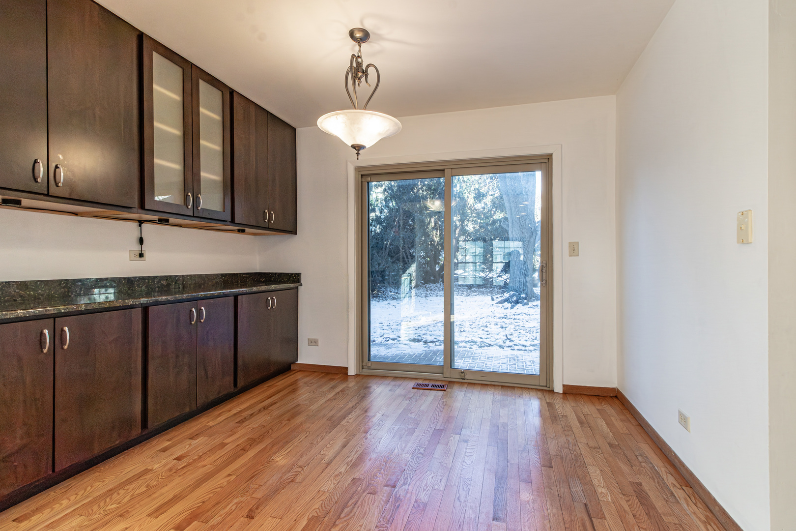 640 Sanders Court Gurnee, IL 60031 - Photo 9 of 38 a view of a kitchen with wooden floor and iron stairs