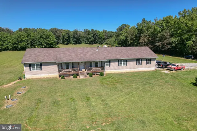 a aerial view of a house with swimming pool table and chairs