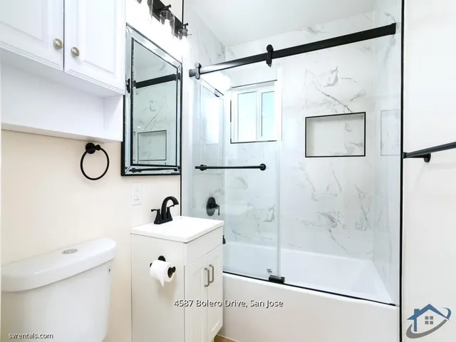 a bathroom with a sink mirror and a shower