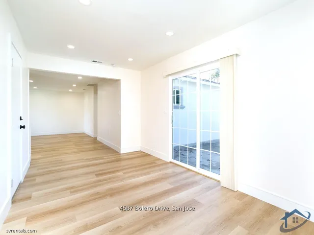 a large white room with wooden floor