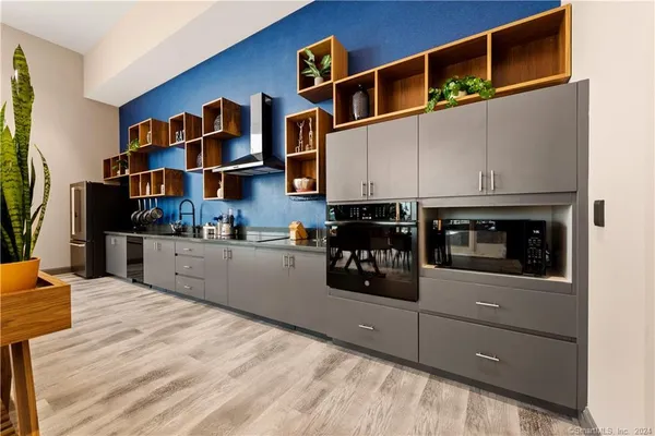 a kitchen with stainless steel appliances granite countertop a stove and cabinets