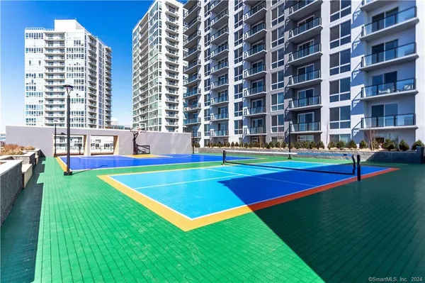 a view of pool with tall trees and grass