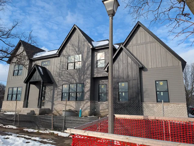 a front view of a house with large windows