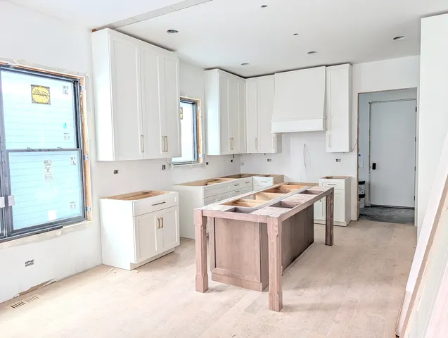 a kitchen with a stove sink and cabinets