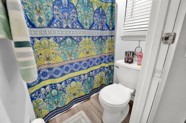 a white toilet sitting next to a sink