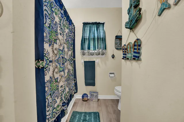 wooden floor in a bathroom next to a window