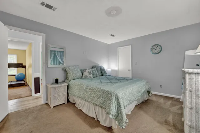 a bedroom with a bed and a lamp