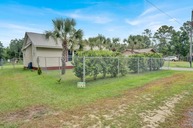 a view of a house with a backyard