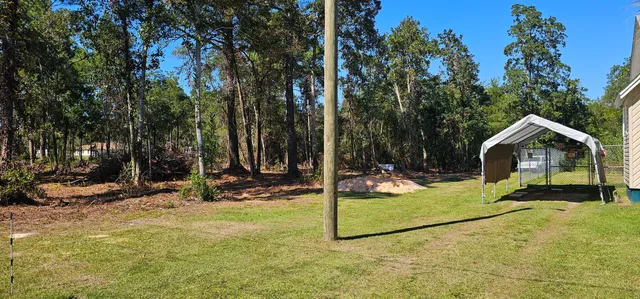 a view of a house with backyard porch and sitting area