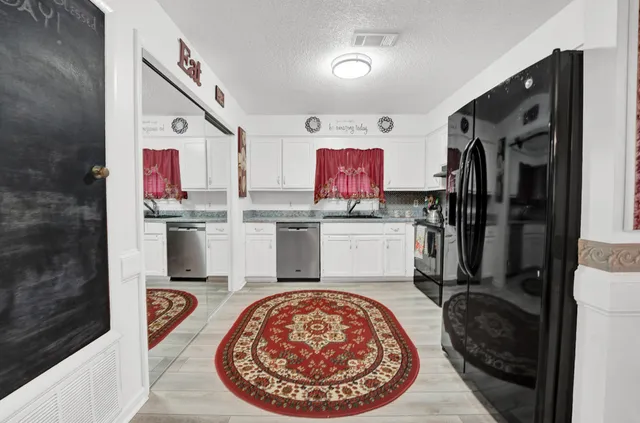 a kitchen with stainless steel appliances kitchen island granite countertop a refrigerator and stove