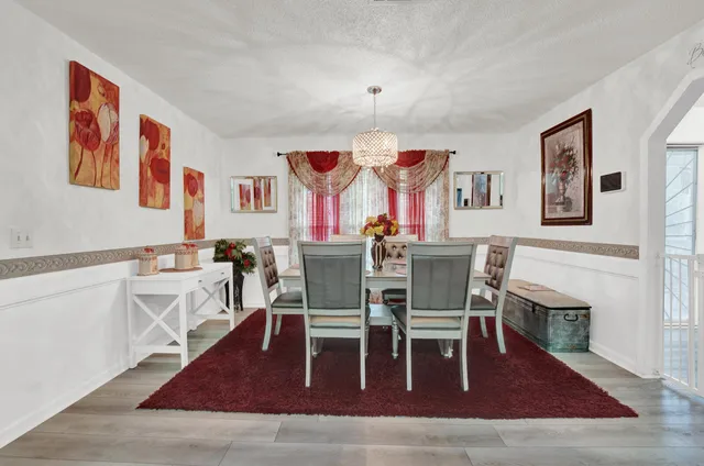 a dining room with furniture a rug and wooden floor