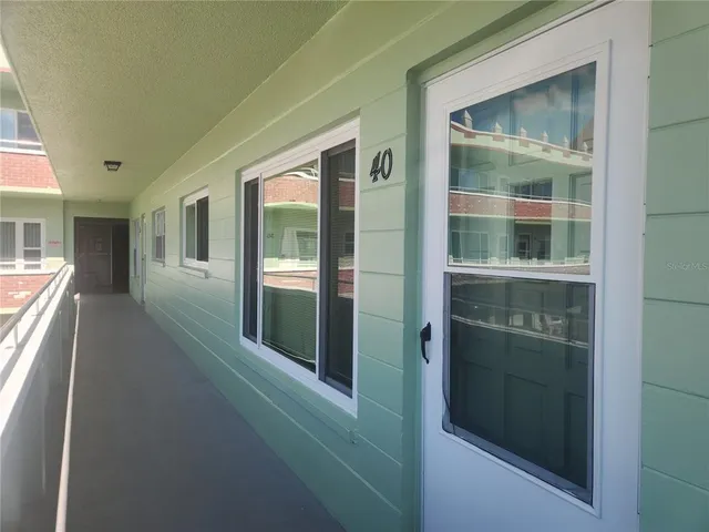 a view of a brick house with a large window