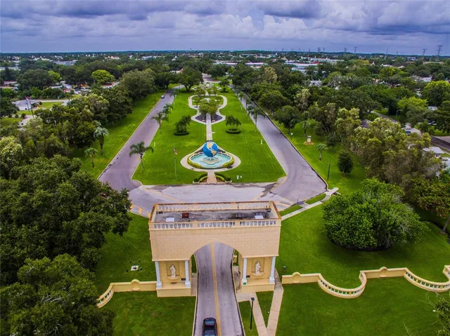 an aerial view of a house with a yard and lake view