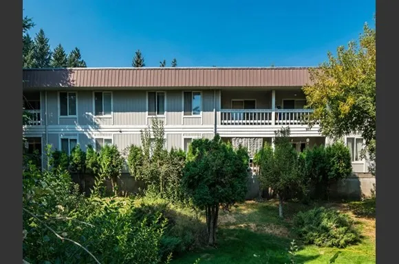a view of house with yard and green space