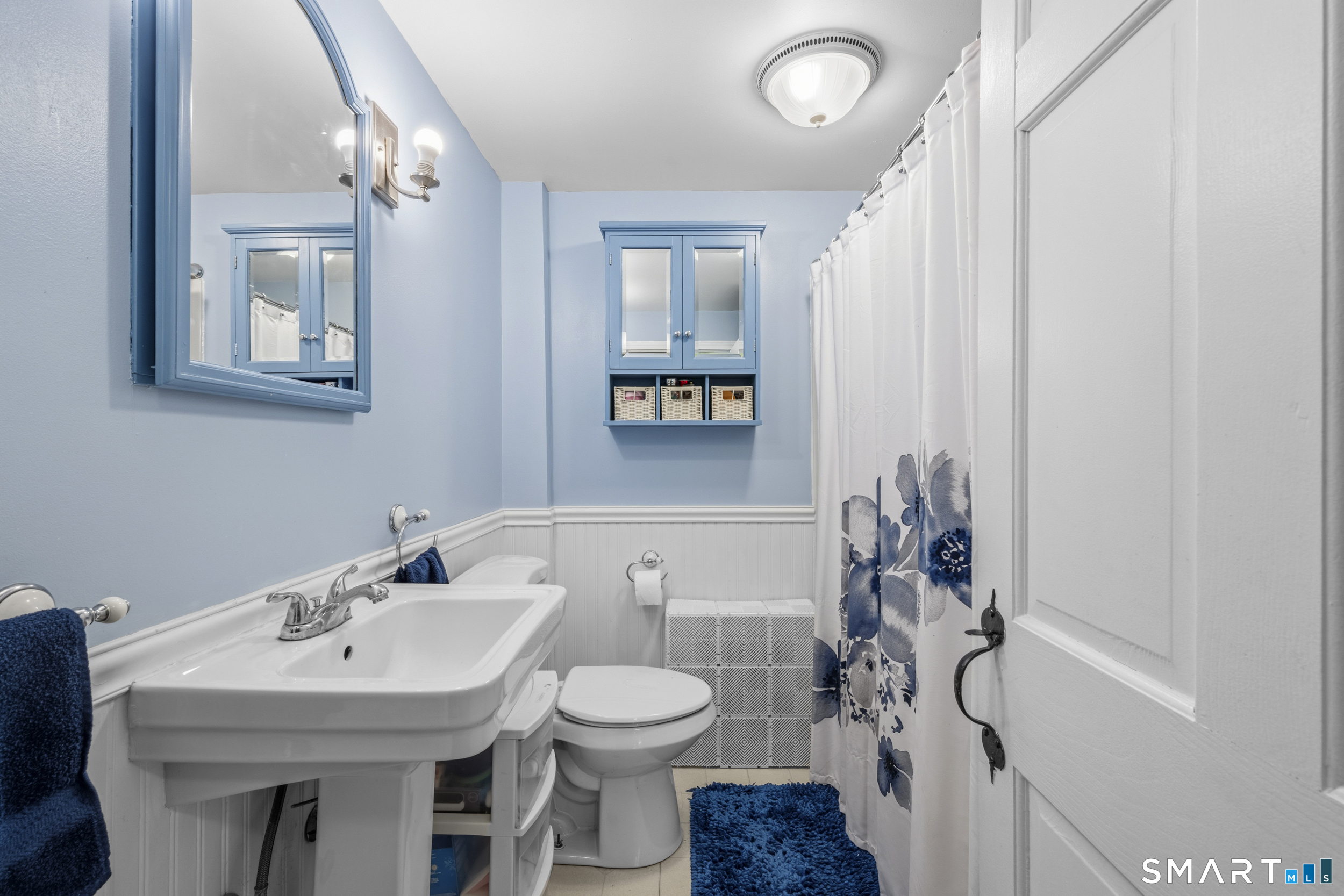 26 Field Street Stonington, CT 06379 - Photo 12 of 20 a bathroom with a toilet sink and mirror