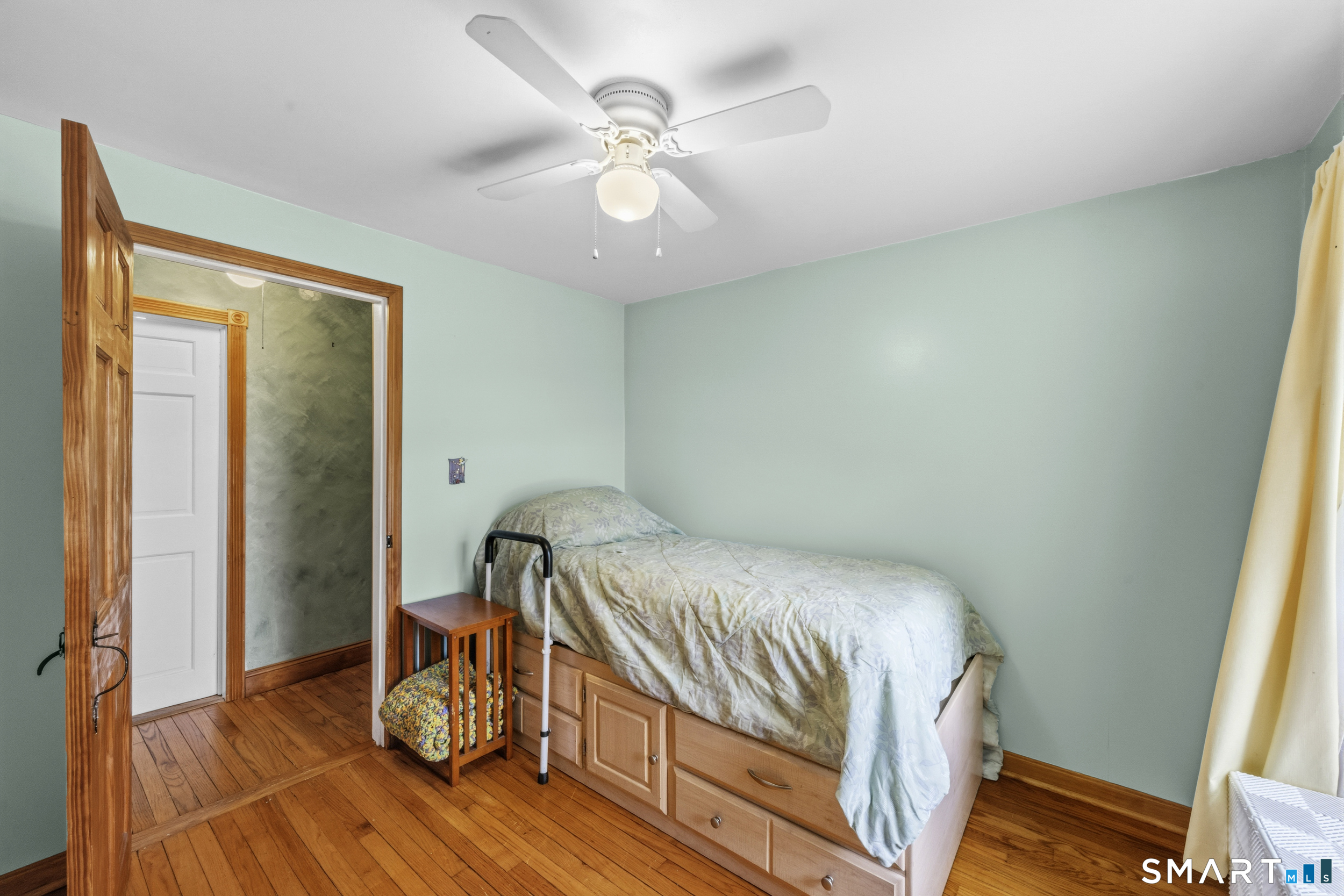 26 Field Street Stonington, CT 06379 - Photo 13 of 20 a bedroom with a bed and a chandelier