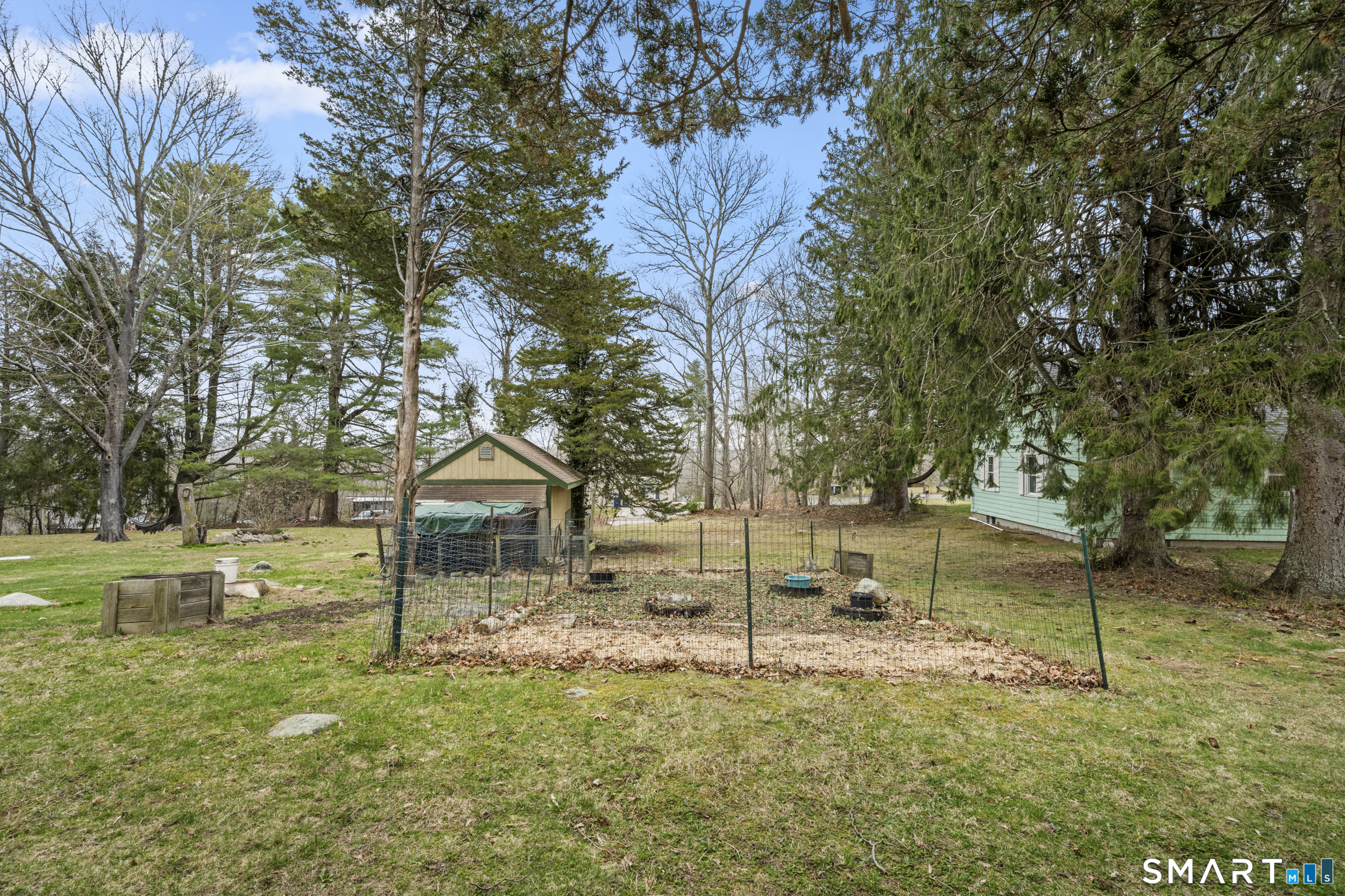 26 Field Street Stonington, CT 06379 - Photo 20 of 20 a backyard of a house with lots of green space