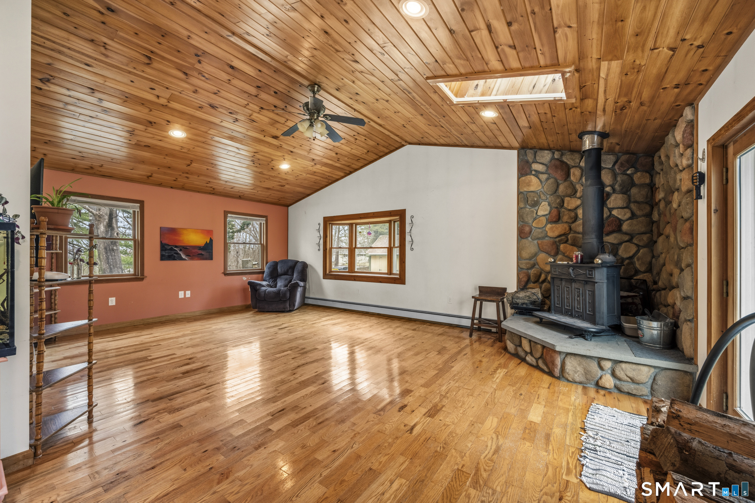 26 Field Street Stonington, CT 06379 - Photo 4 of 20 a view of a livingroom with furniture hardwood floor and a ceiling fan