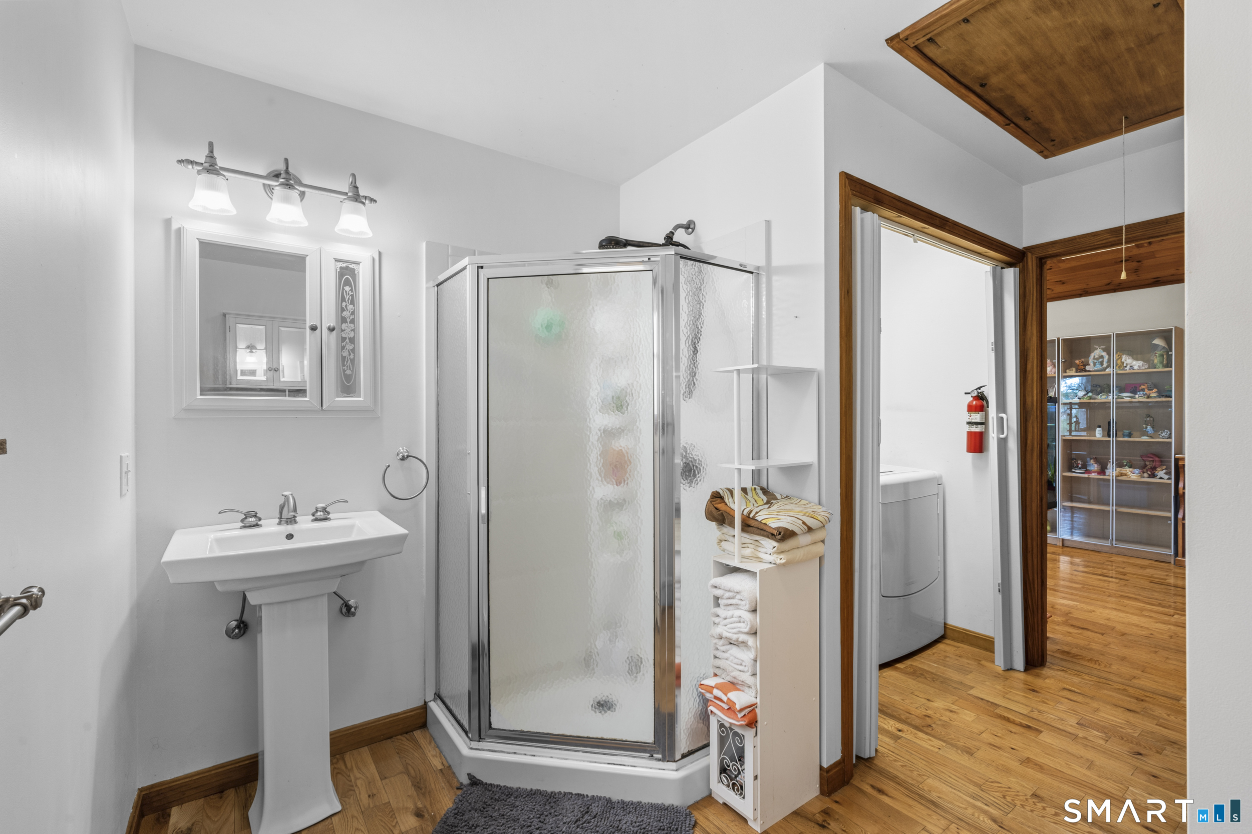 26 Field Street Stonington, CT 06379 - Photo 6 of 20 a bathroom with a sink mirror and shower
