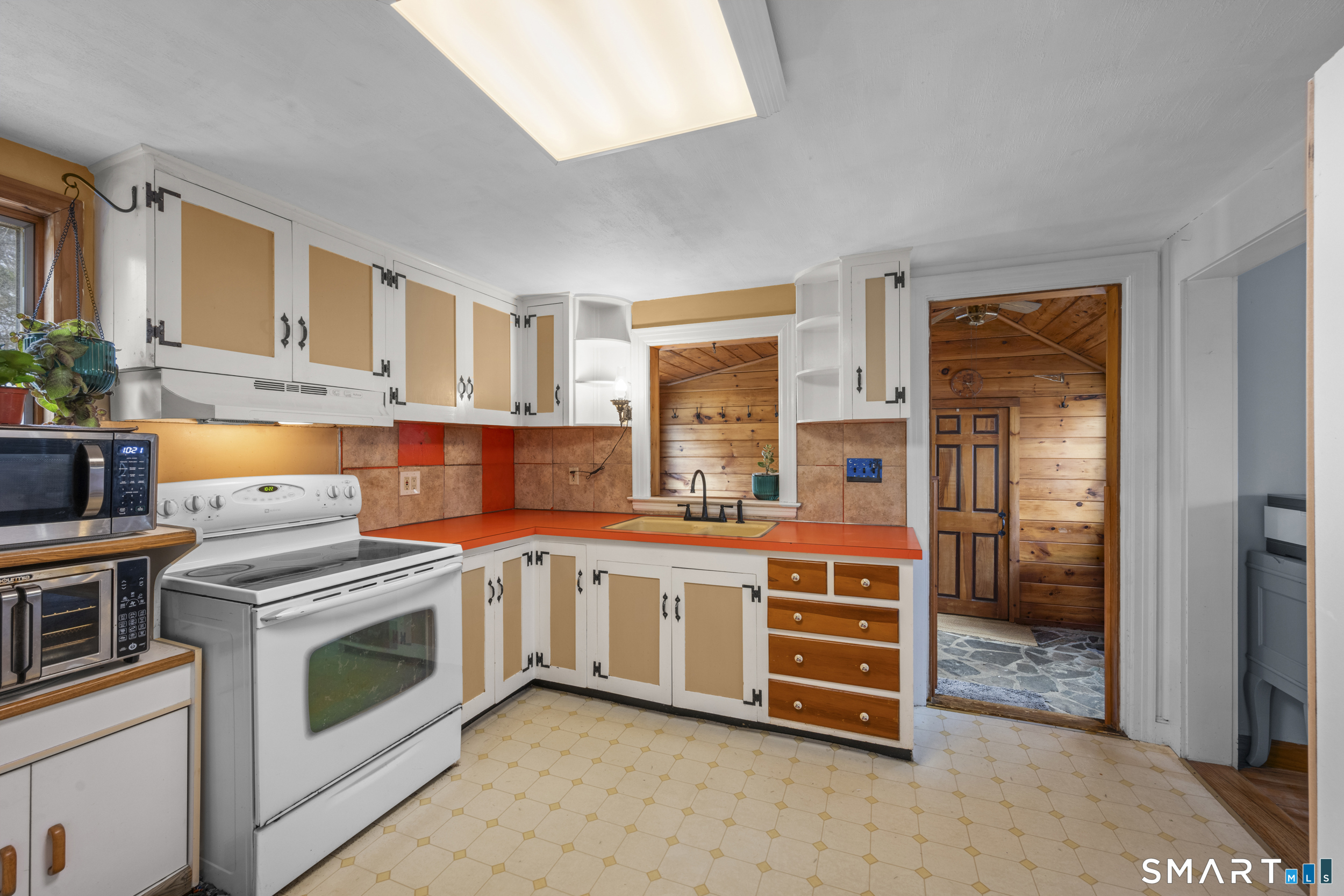 26 Field Street Stonington, CT 06379 - Photo 8 of 20 a kitchen with stainless steel appliances granite countertop a stove and a sink