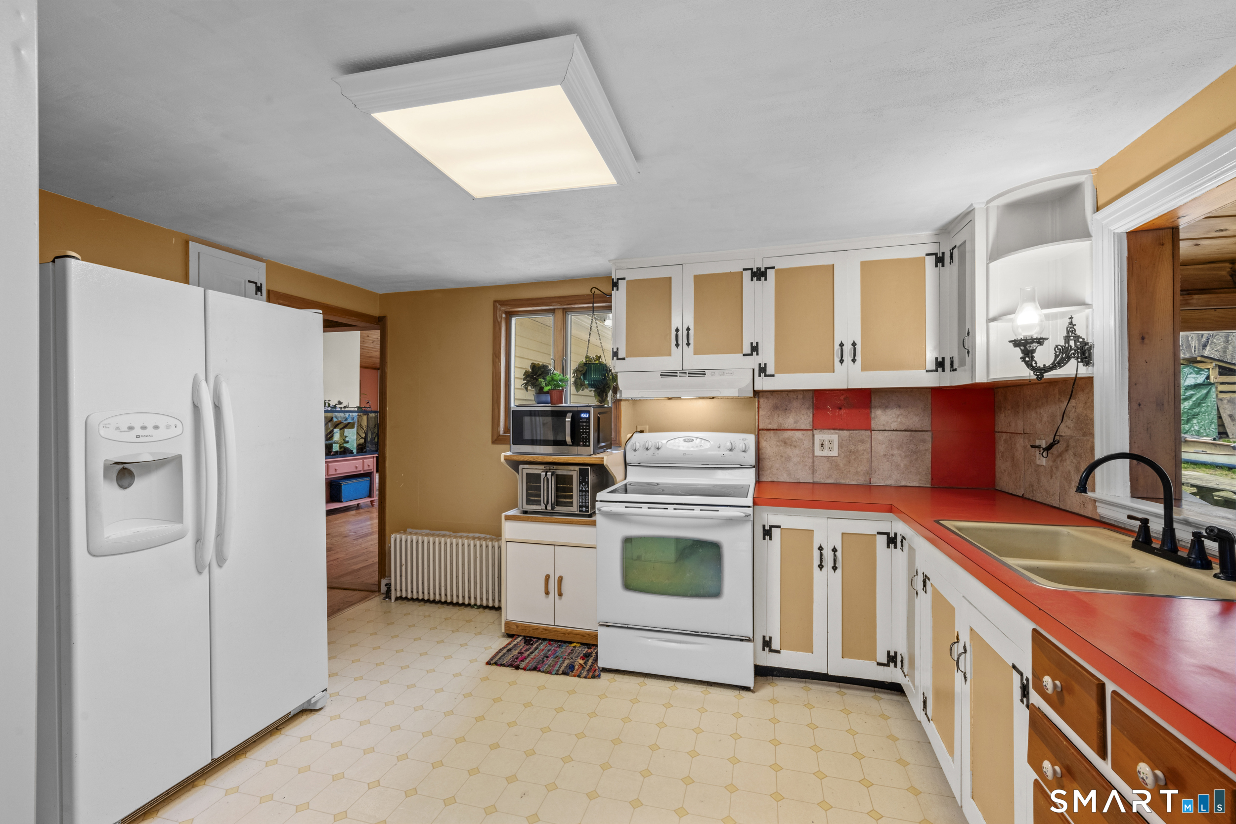 26 Field Street Stonington, CT 06379 - Photo 9 of 20 a kitchen with stainless steel appliances granite countertop a stove a sink and a refrigerator