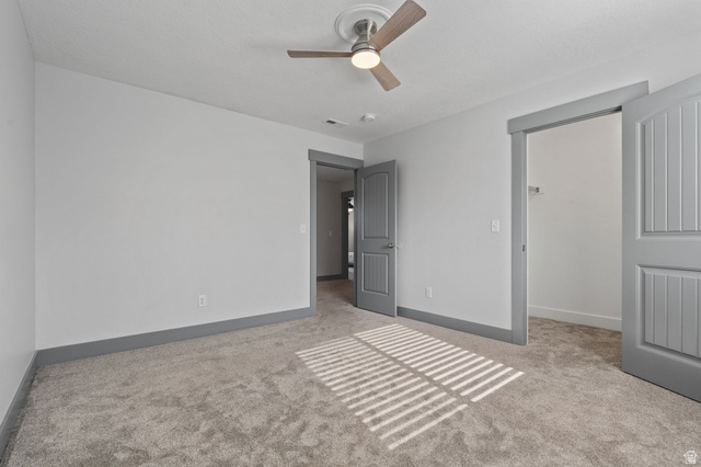 7822 North Copperbend Road Eagle Mountain, UT 84005 - Photo 24 of 46 Plush carpet flooring, ceiling fan with light fixture, gray trim, and paneled interior doors