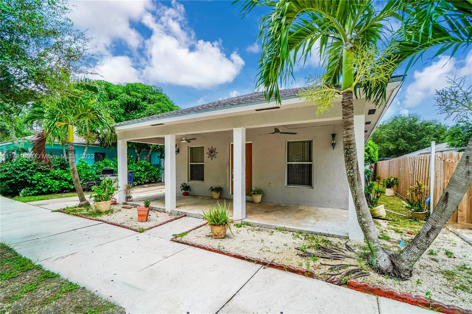24313 Southwest 130th Avenue Homestead, FL 33032 - Photo 1 of 23 a view of a house with backyard sitting area and garden