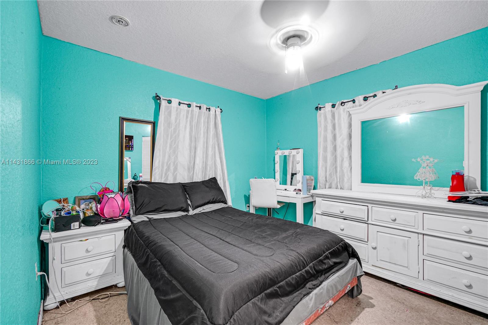 24313 Southwest 130th Avenue Homestead, FL 33032 - Photo 12 of 23 a bedroom with a bed and a flat screen tv