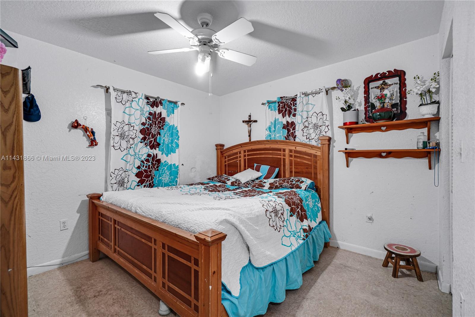 24313 Southwest 130th Avenue Homestead, FL 33032 - Photo 13 of 23 a bedroom with a bed and a chandelier