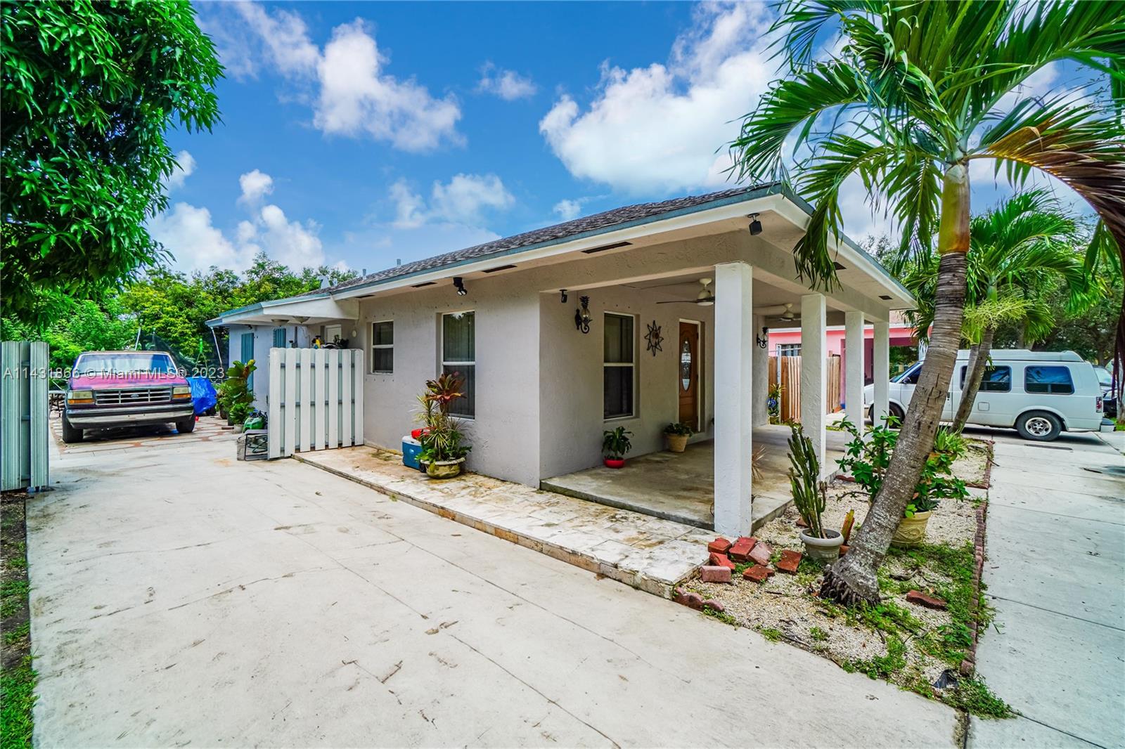 24313 Southwest 130th Avenue Homestead, FL 33032 - Photo 18 of 23 a front view of a house with garden