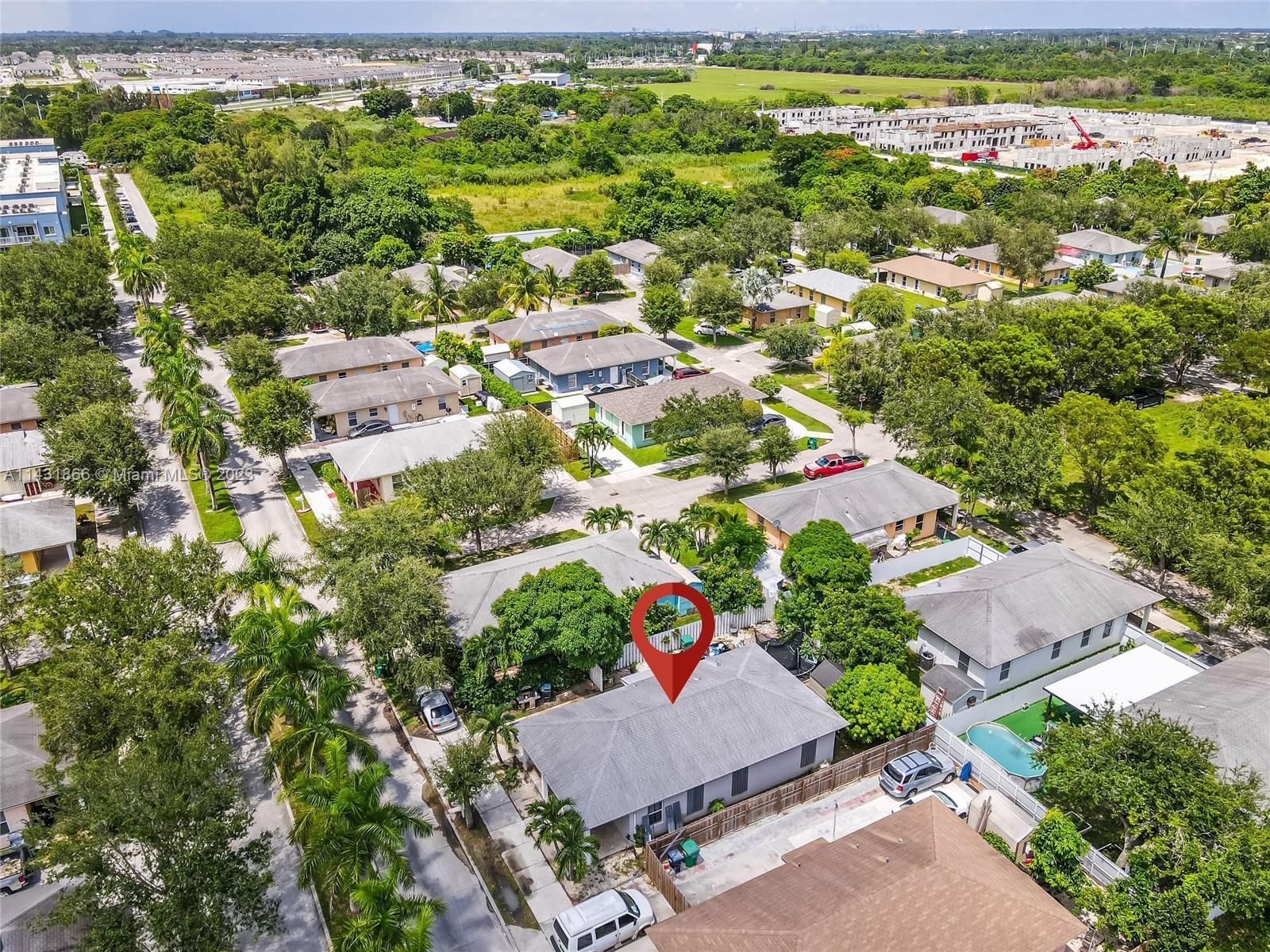 24313 Southwest 130th Avenue Homestead, FL 33032 - Photo 21 of 23 an aerial view of residential houses with outdoor space and trees