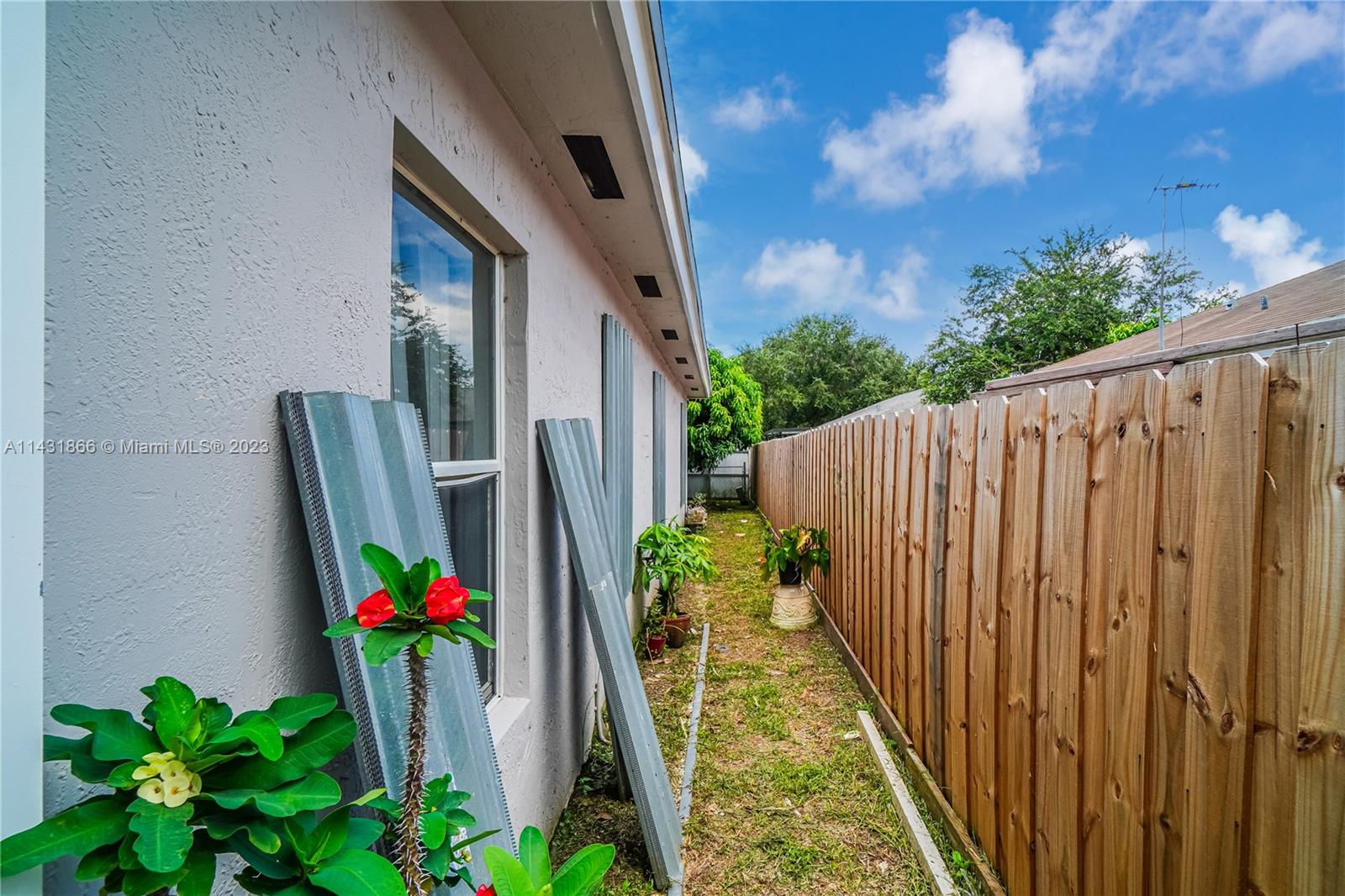 24313 Southwest 130th Avenue Homestead, FL 33032 - Photo 23 of 23 a flower garden in front of a house