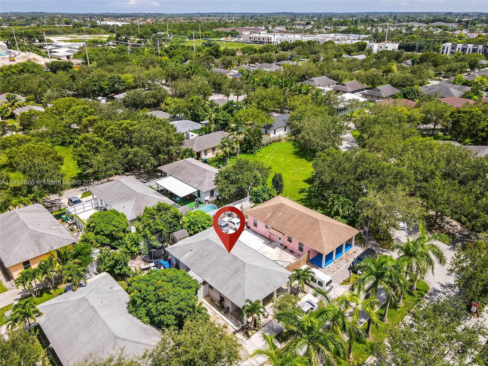 24313 Southwest 130th Avenue Homestead, FL 33032 - Photo 3 of 23 an aerial view of residential houses with outdoor space