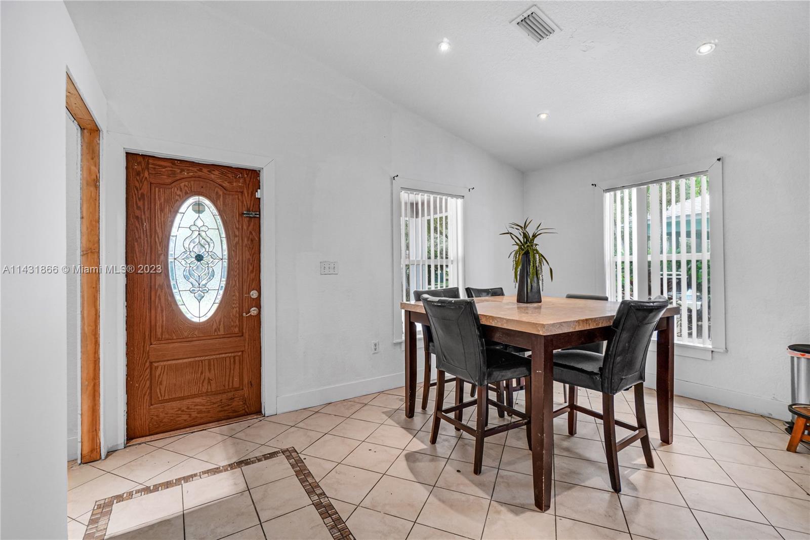 24313 Southwest 130th Avenue Homestead, FL 33032 - Photo 6 of 23 a view of a dining room with furniture and window