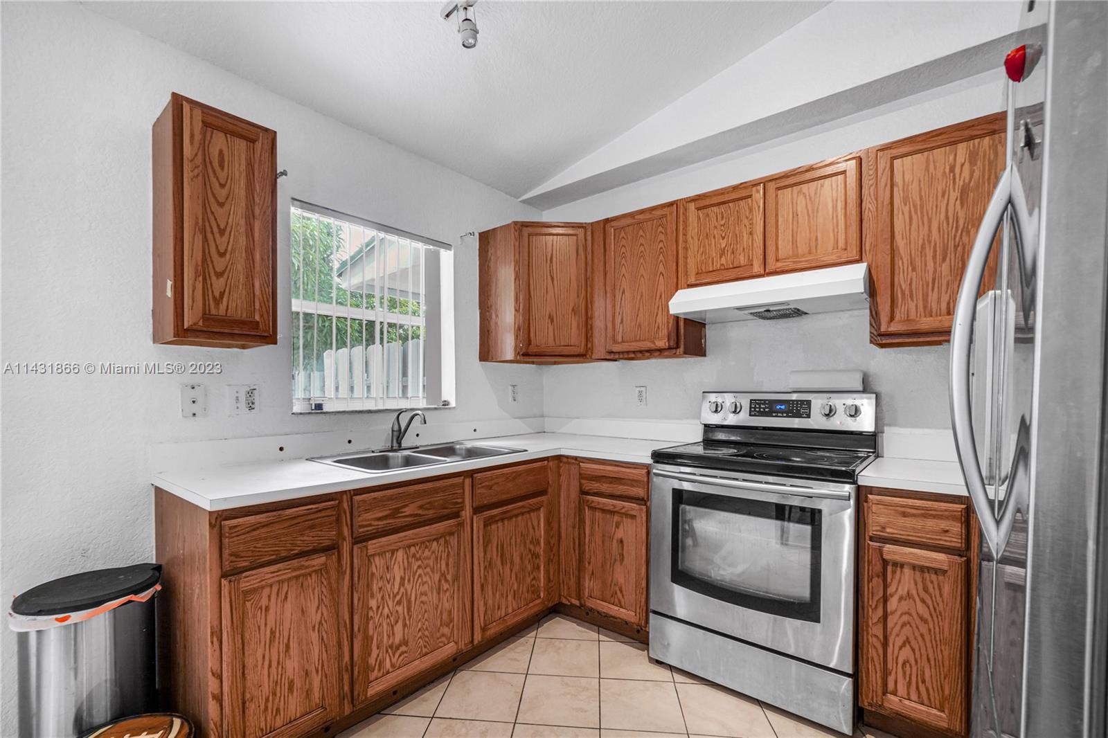 24313 Southwest 130th Avenue Homestead, FL 33032 - Photo 8 of 23 a kitchen with a sink stove and cabinets